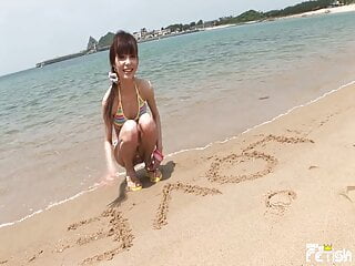 Skinny Japanese chick enjoys having a photoshoot on a beach